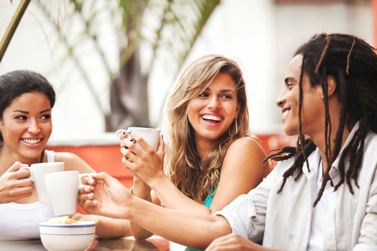 Three-Cheerful-Young-Friends-Happy-Smile-Drink-Coffee-Tea-Laugh